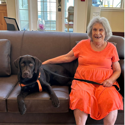 Cottages of Clayton Resident with Chocolate Lab